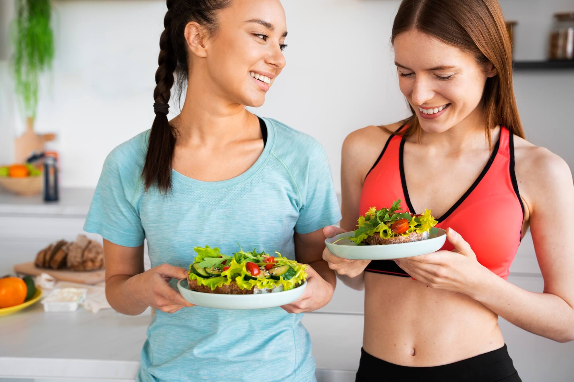 front-view-smiley-women-with-healthy-food(1)